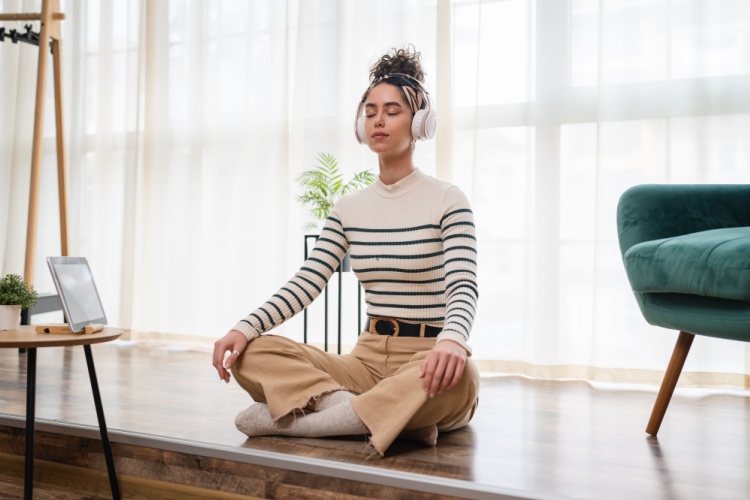 A woman practicing mental fitness exercises and meditation outdoors